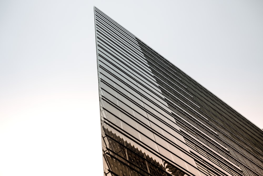 low-angle photography of curtain building under white sky during daytime