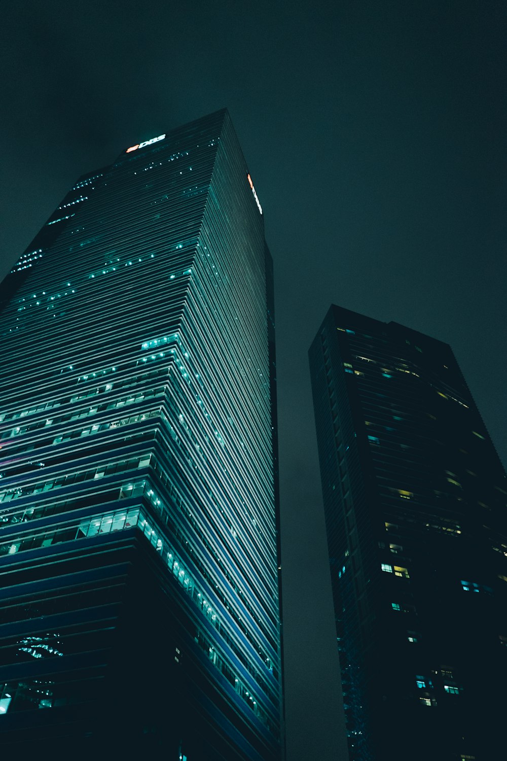 low-angle photography of high-rise buildings during nighttime