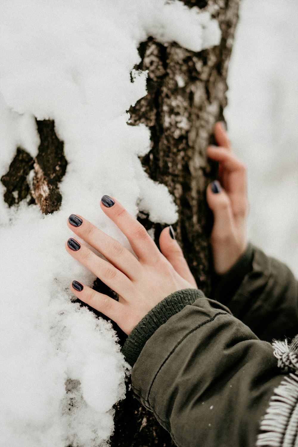 person touching gray stone