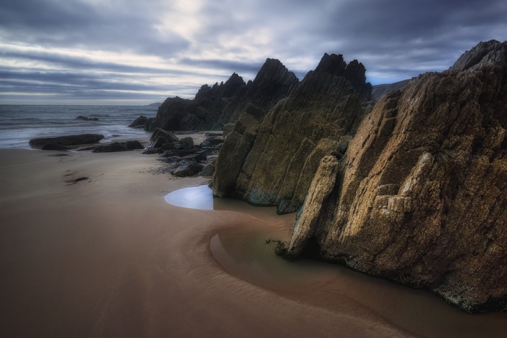 black rock near body of water