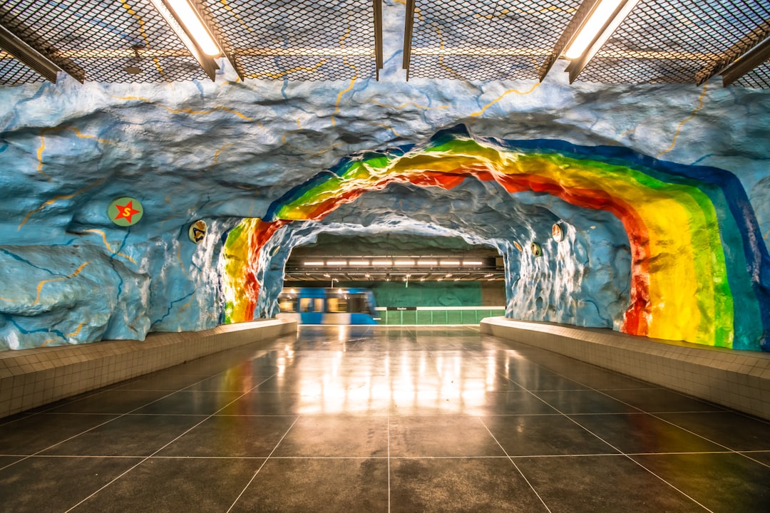 brown floor tile under rainbow tunnel