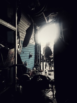 A close-up of a Bangladeshi inventor working on a sleek tech gadget in a bright, modern workshop.