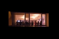 A group photo of service providers standing together in a softly lit room with subtle deep indigo accents.