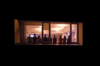 A group of happy customers enjoying electricity in their well-lit homes.