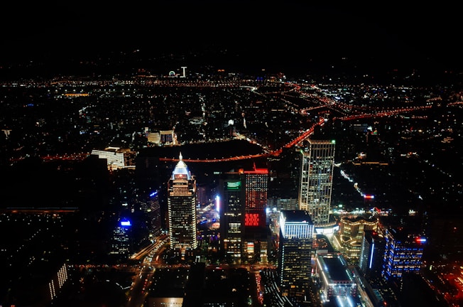 City skyline at night with vibrant lights and busy streets