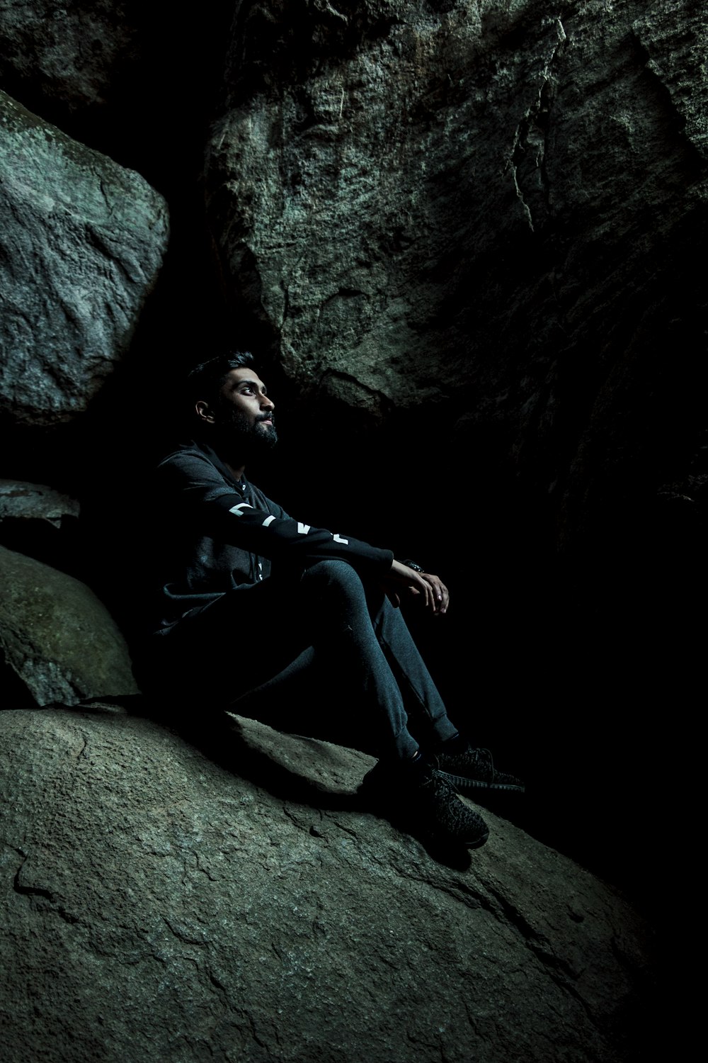 man sitting inside cave