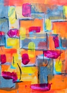 A contemporary abstract painting with bold strokes and vivid hues displayed on a white wall.