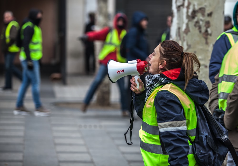 woman using white and red megaphone