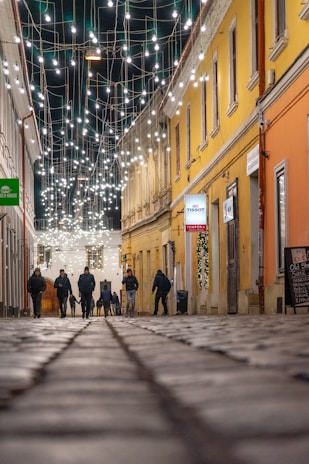 A group of travelers enjoying a guided walk through a vibrant village street.
