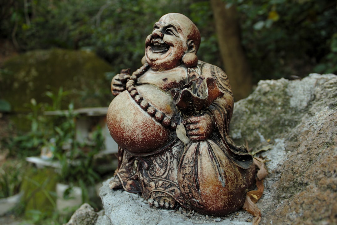 Hotei Bhudda figurine on rock