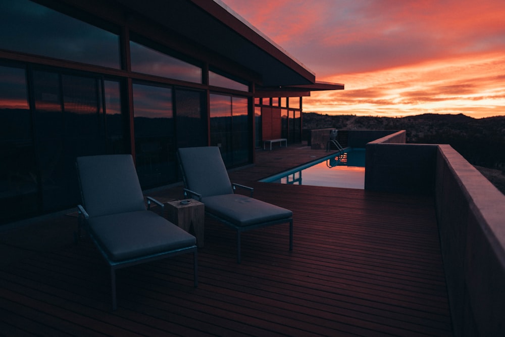 lounge chairs on wooden porch during golden hour