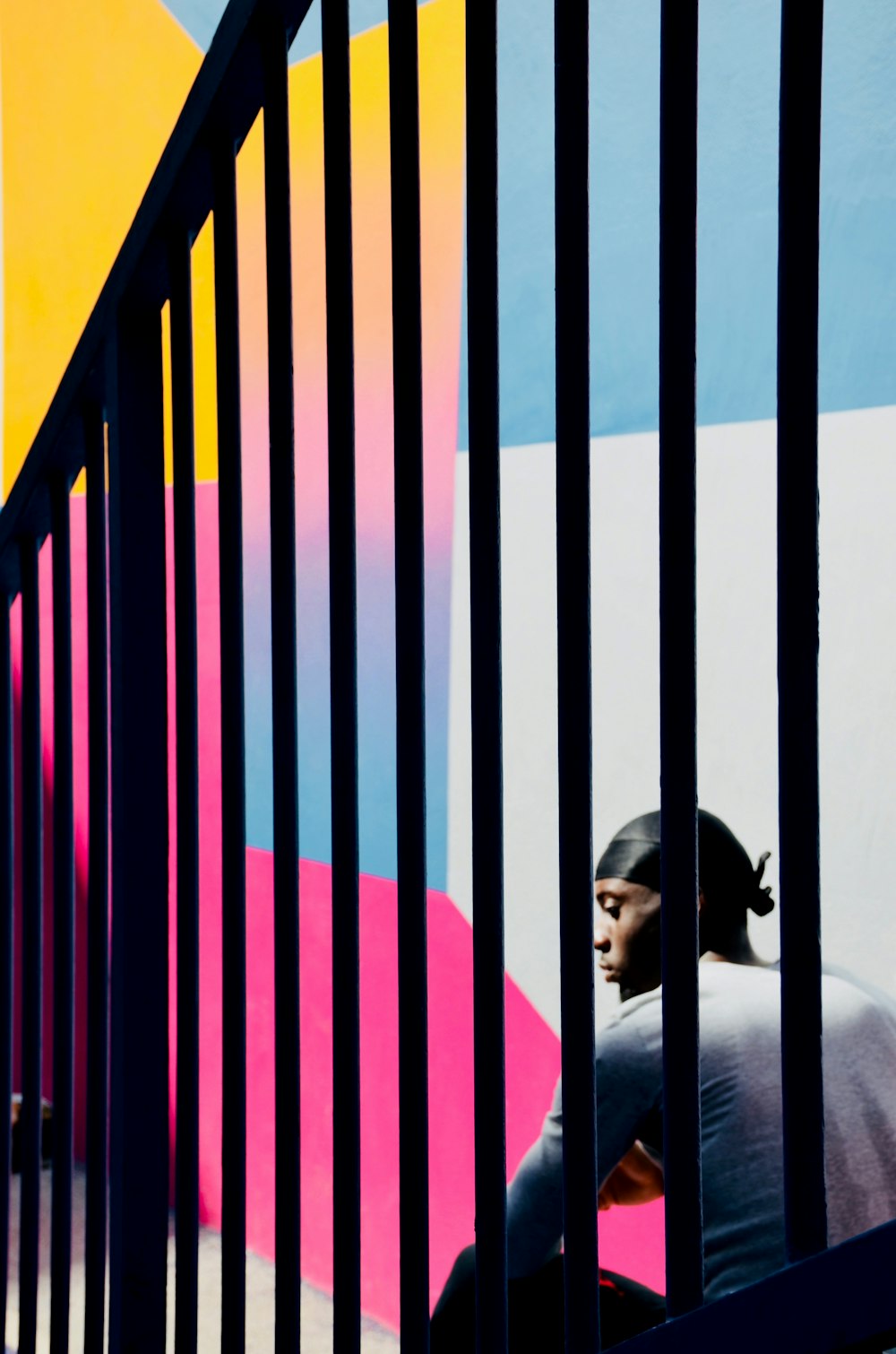 man sitting beside railing