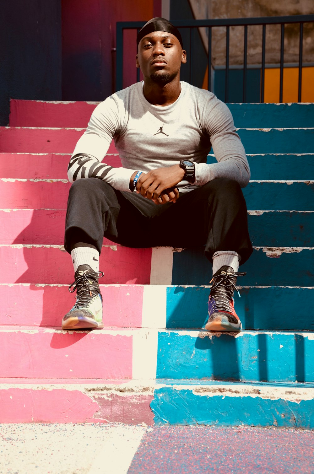 man sitting on concrete stairs inside building