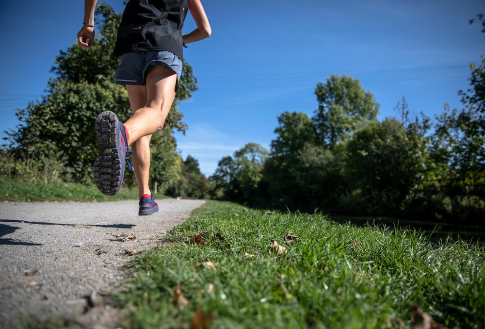 person running between grass fields