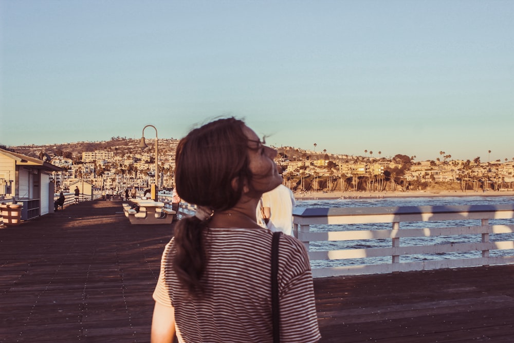 woman standing near concrete fence