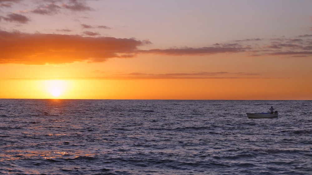 man sailing on boat during sunset