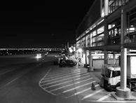 A night view of a well-lit international airport runway, ready for takeoff.