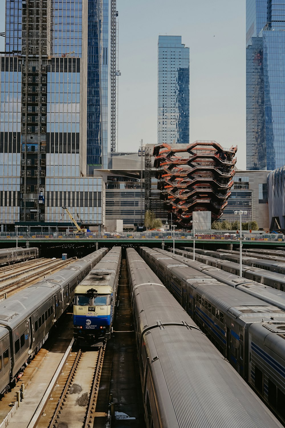 train in rail near curtain wall building during daytime