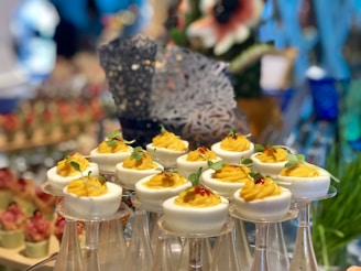 Granny Reds’ pickled eggs displayed on a wooden board with fresh herbs and spices around.