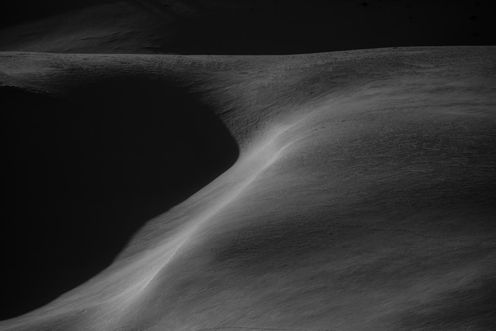 a black and white photo of a sand dune