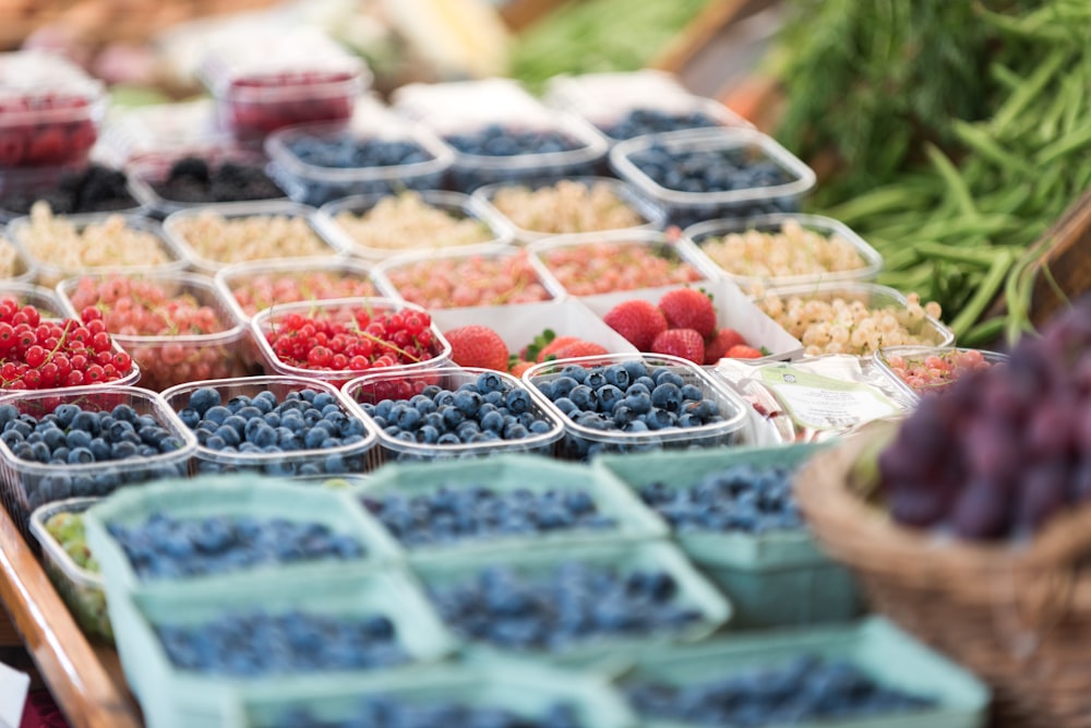 selective focus photography of assorted fruits on plastic food containers