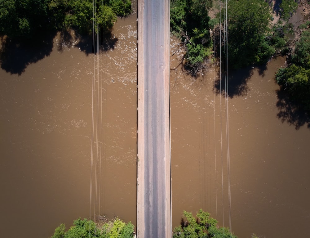 aerial photography of road above body of water during daytime