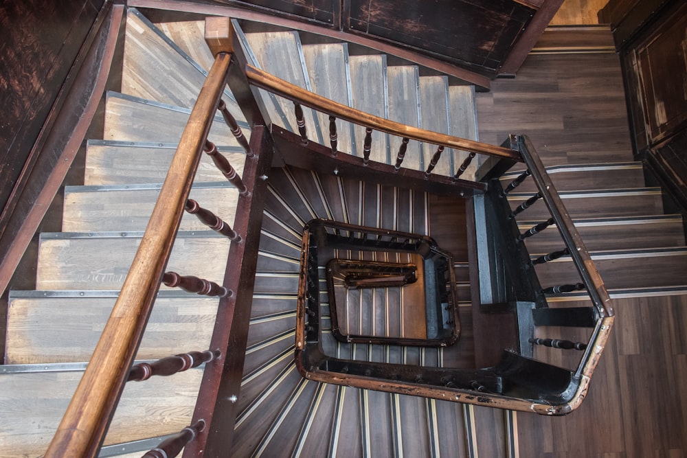 upper view of brown wooden spiral stairs