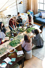 women crafting with greenery at workshop table