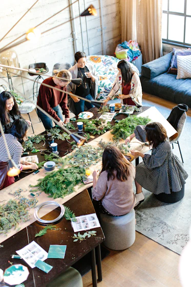 women crafting with greenery at workshop table