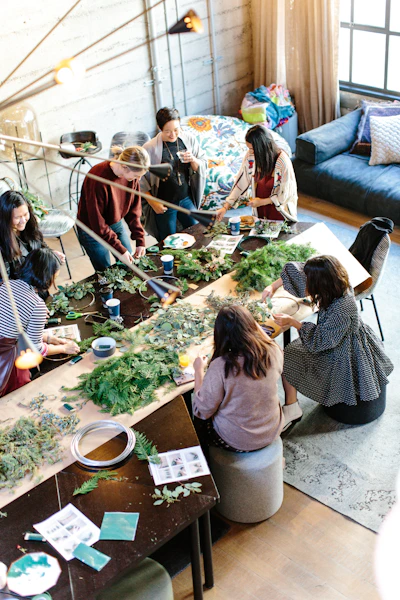 women crafting with greenery at workshop table