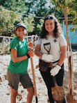 two women holding shovels