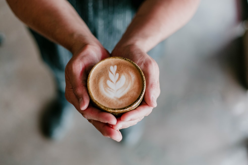 person holding coffee cup