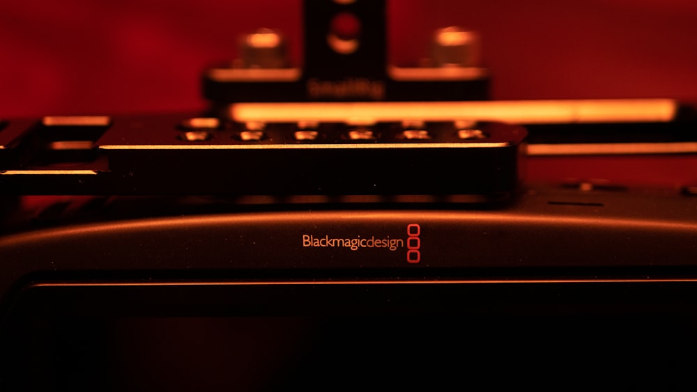 a black electronic device with a red background