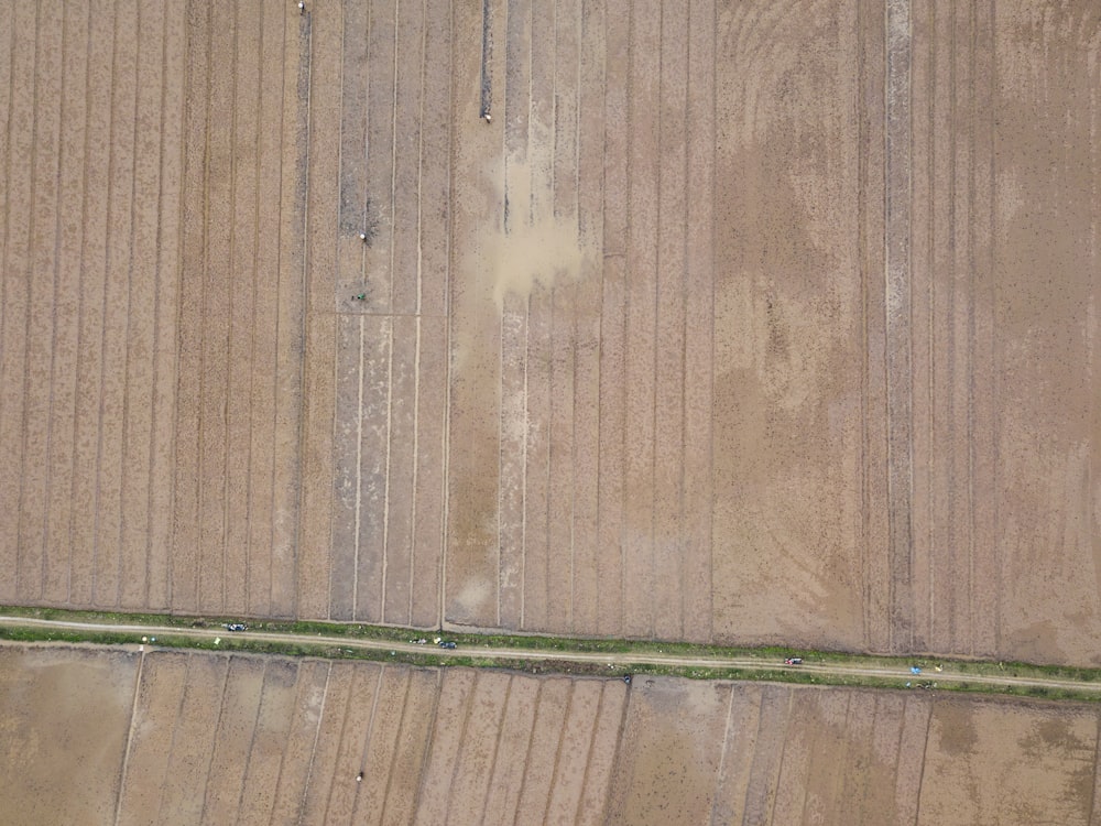 an aerial view of a field with a road running through it