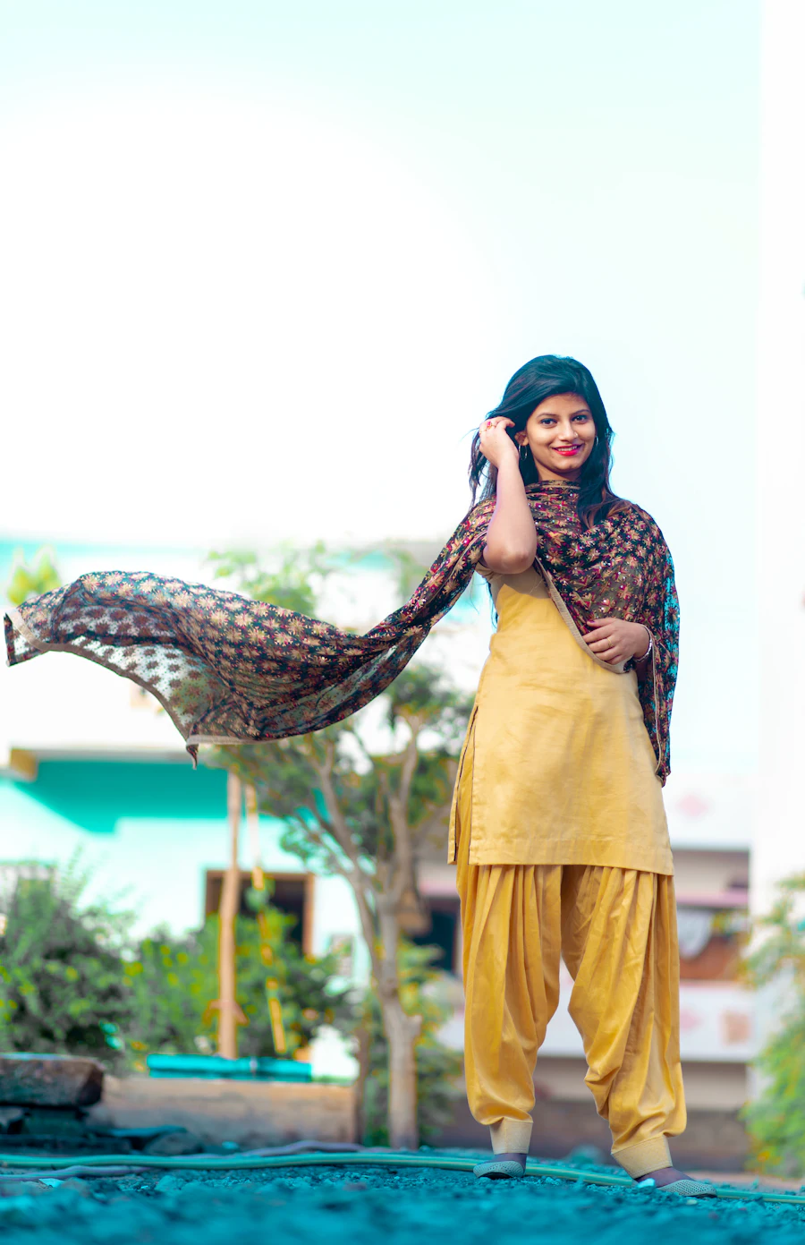 Woman wearing a yellow Punjabi Patiala salwar suit with dupatta