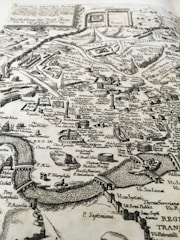 A detailed ancient-style map overlaid with modern route markers and icons.