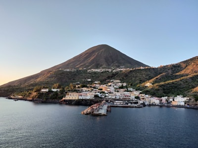 body of water near brown mountain range