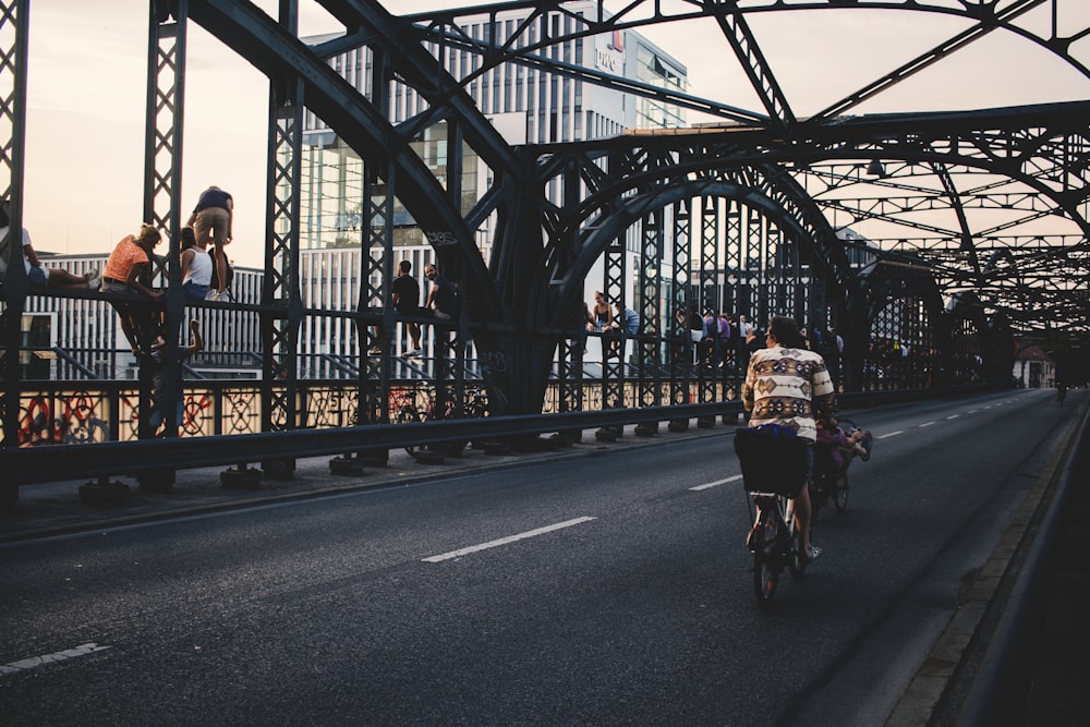 person riding bike on bridge