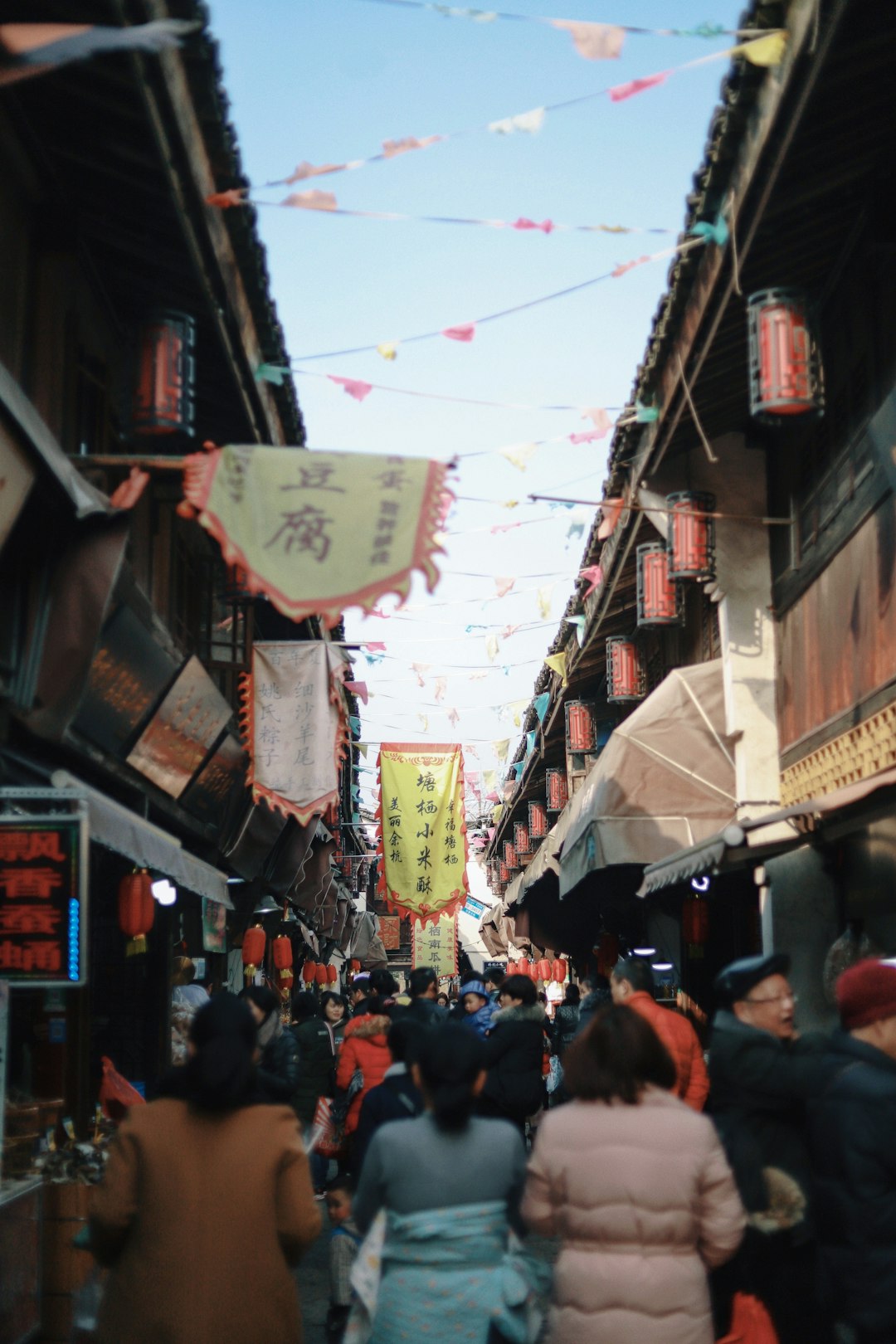 people gathering between buildings during daytime