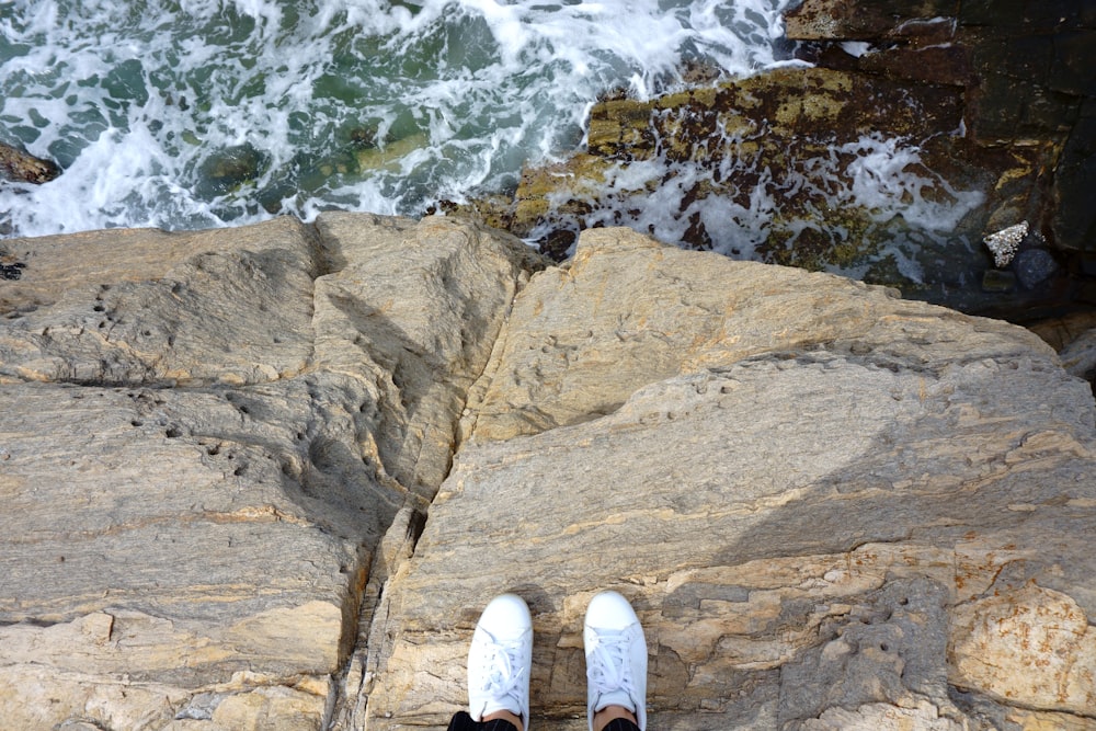 person standing on rock