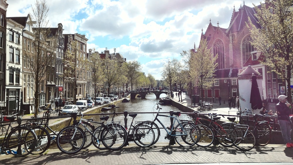 bicycles parked on fence near river