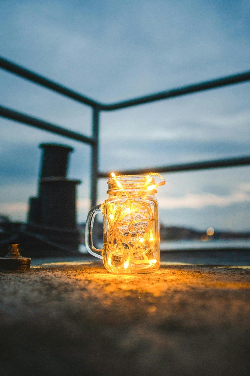 clear glass jar mug filled with mini string lights turned on