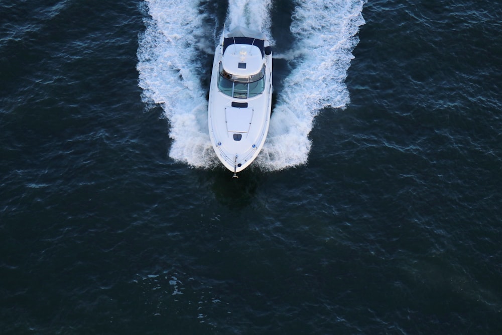 white speedboat in the middle of body of water