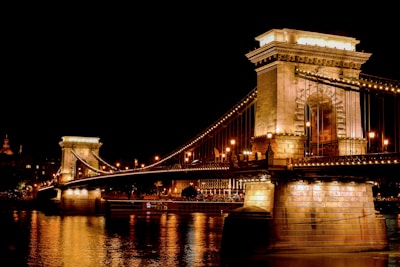A nighttime shot of a well-lit bridge construction showcasing structural details and safety measures.