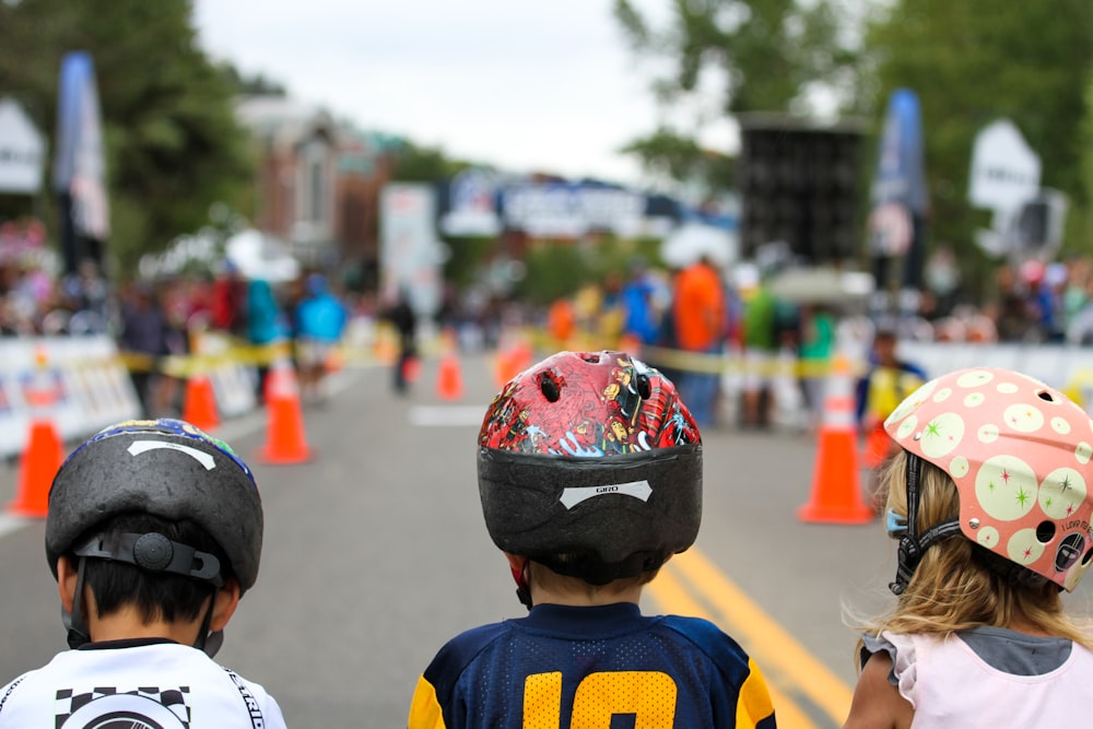 girl and boy wearing multicolored helmets