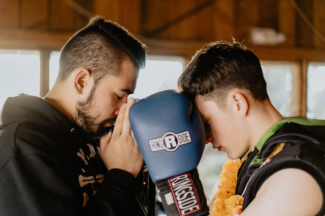two men praying inside room