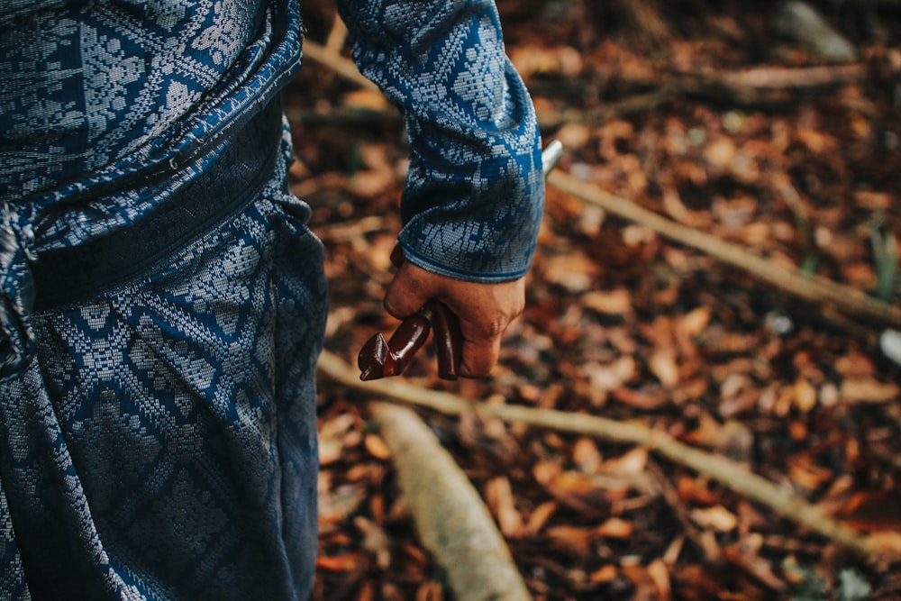 selective focus photography of person holding rod