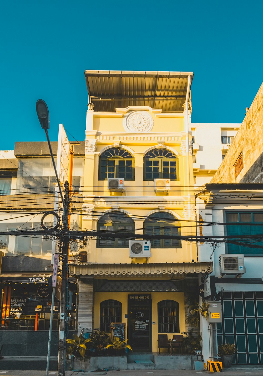 yellow concrete 3-storey house