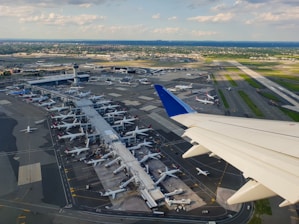 Aerial view of a busy international airport showcasing modern terminals and runways.