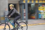 Side view of a person cycling through the city in Mark X Apparel activewear.
